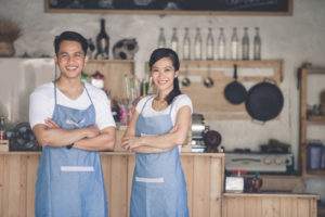 men and women in kitchen